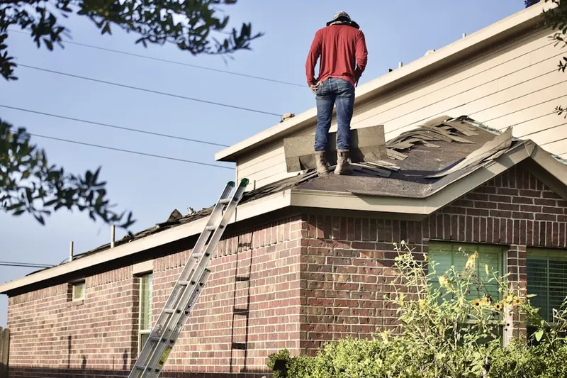 Professional roofer working on a residential roof in Ross Downs Estates